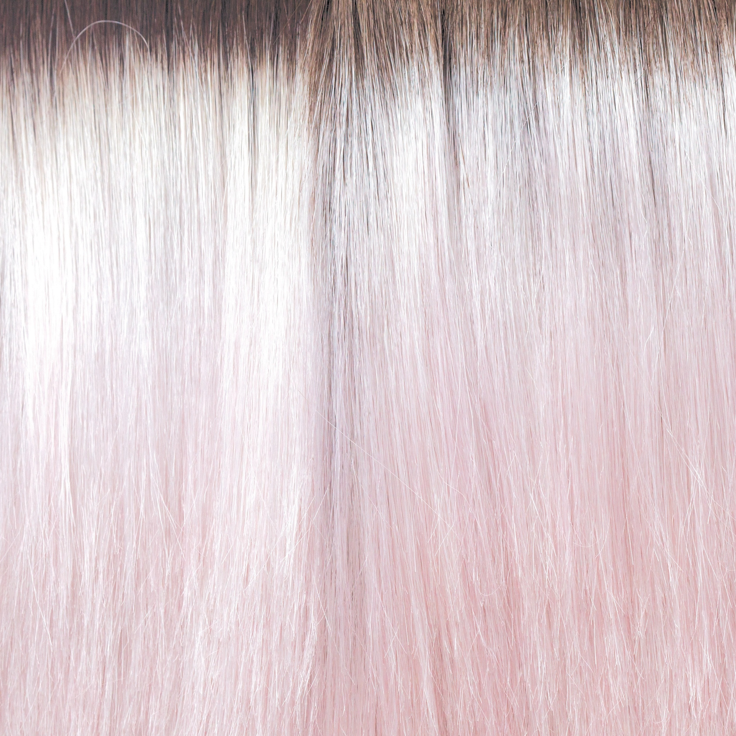 Bubblegum-R - A stunning silver, greyish pink with a slight bubble gum blond tone throughout the mid lengths and ends. This grows from an icy brown regrowth root making the piece look extremely realistic, with a pink water color toner Bubble Gum-R is so on trend.