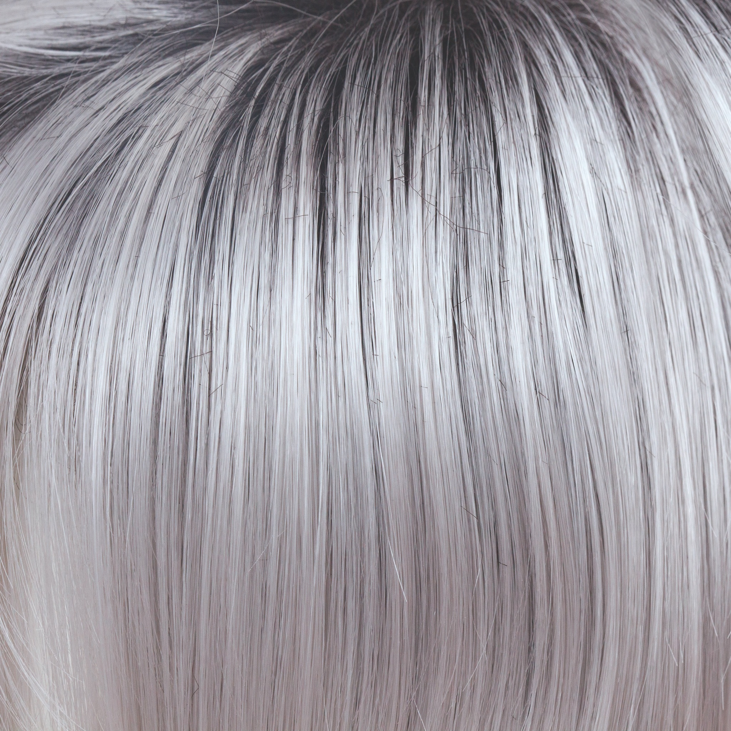 Illumina-R - A truly stunning color! This striking iridescent white gives off hues of silver and pales purples. The dark brown root has an appearance of natural regrowth. Illumina-R is fashion forward and toned to perfection.